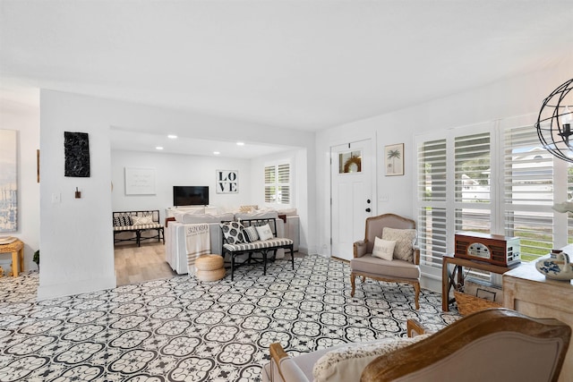 living room with light hardwood / wood-style flooring and a notable chandelier