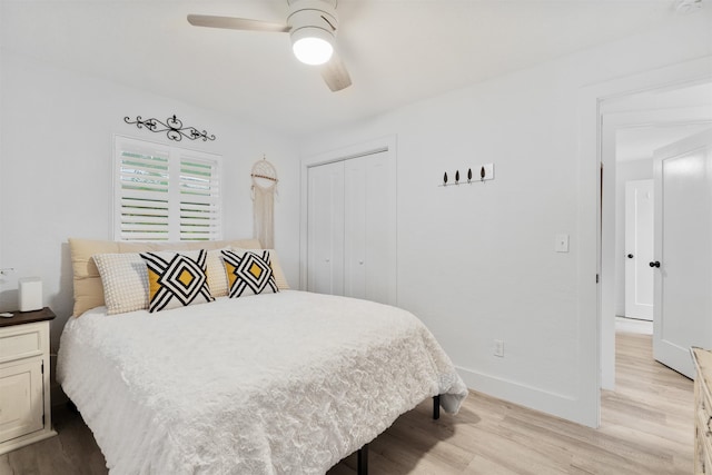 bedroom with light wood-type flooring, a closet, and ceiling fan