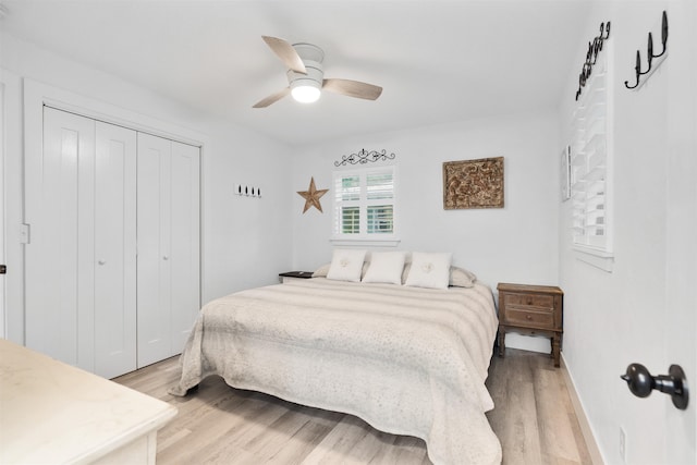 bedroom featuring light wood-type flooring, a closet, and ceiling fan