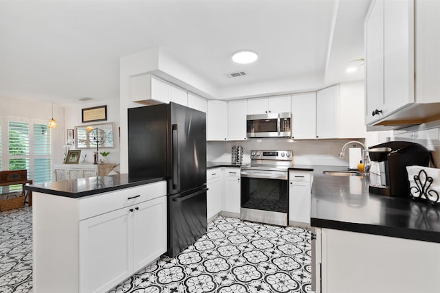 kitchen featuring white cabinets, sink, hanging light fixtures, kitchen peninsula, and stainless steel appliances