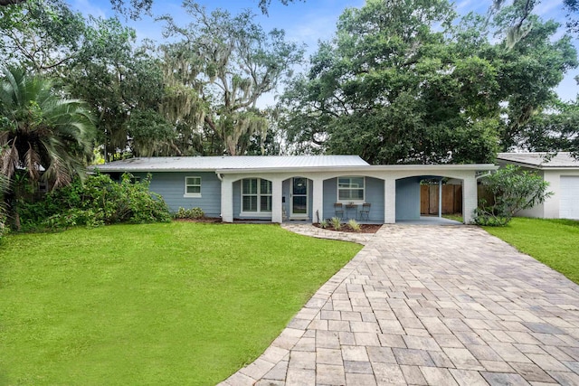 ranch-style house with a front yard and a carport