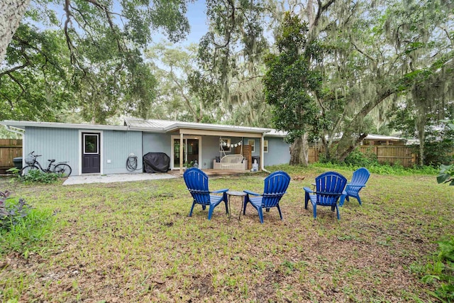 rear view of property with a lawn and a patio area