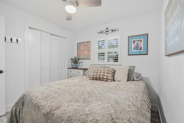 bedroom with hardwood / wood-style floors, a closet, and ceiling fan