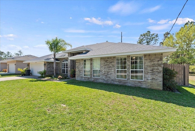 14 Serbian Bellflower Trl, Palm Coast, FL 32164 - view of front of home featuring fence, a garage, concrete driveway, brick siding, and a front lawn