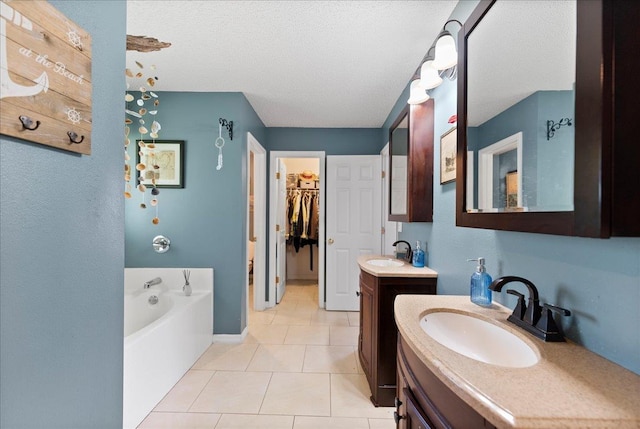 14 Serbian Bellflower Trl, Palm Coast, FL 32164 - bathroom featuring a walk in closet, a bath, a sink, and two vanities