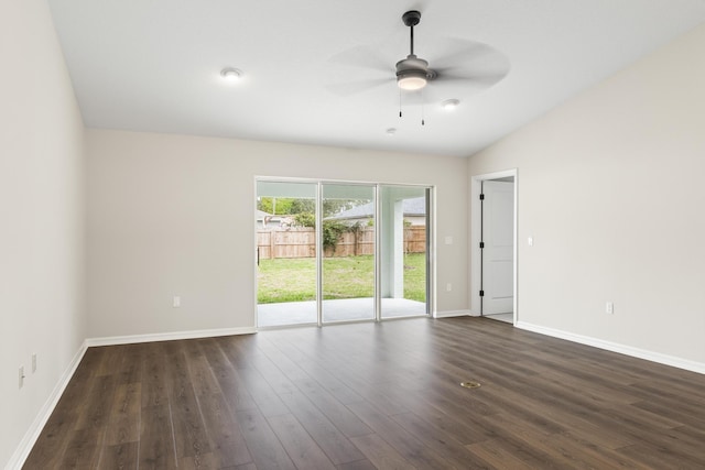 empty room featuring lofted ceiling, baseboards, dark wood-style flooring, and ceiling fan