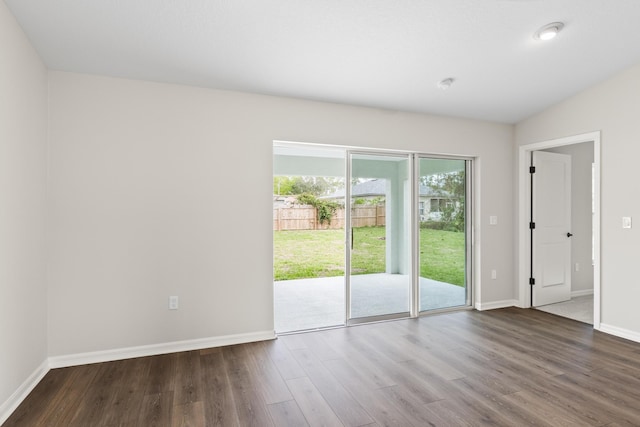 unfurnished room featuring baseboards and dark wood-style flooring