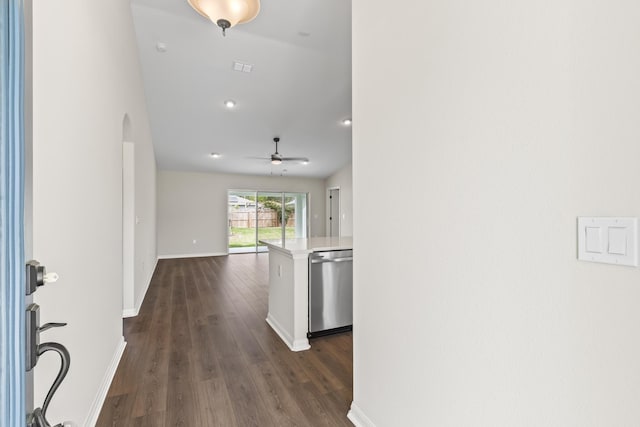 entryway with arched walkways, dark wood finished floors, a ceiling fan, and baseboards