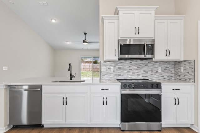 kitchen with a ceiling fan, a sink, white cabinetry, stainless steel appliances, and light countertops