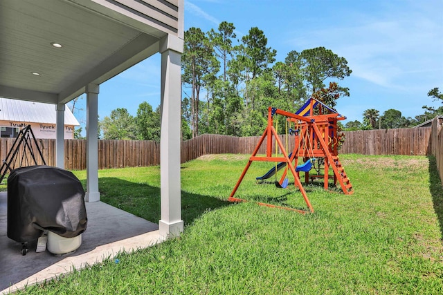 view of yard featuring a patio and a playground