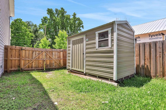 view of outbuilding featuring a lawn