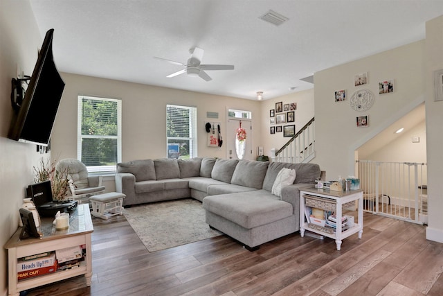 1312 Eisenhower Dr, Saint Augustine, FL 32084 - living room featuring a ceiling fan, wood finished floors, and stairs