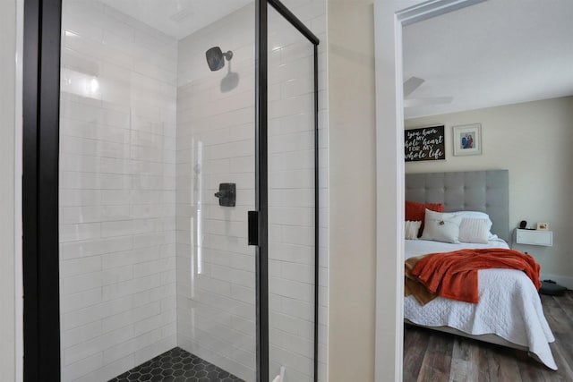 bathroom with an enclosed shower and wood-type flooring