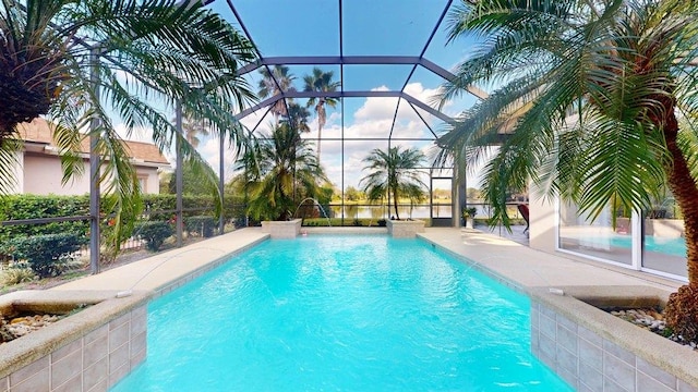 view of pool with pool water feature and a lanai