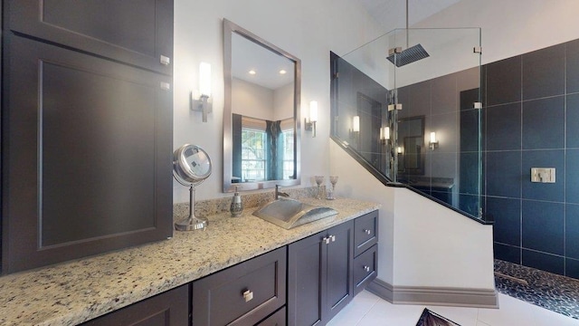 bathroom with vanity and a tile shower