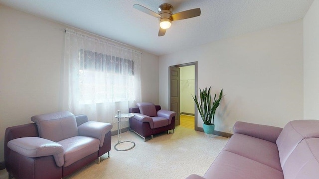 living room featuring a textured ceiling and ceiling fan