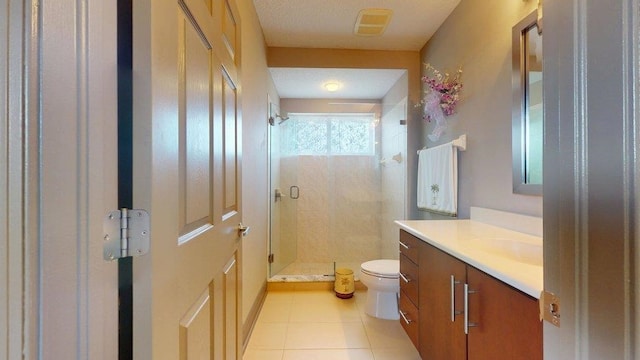 bathroom featuring tile patterned flooring, walk in shower, vanity, and toilet