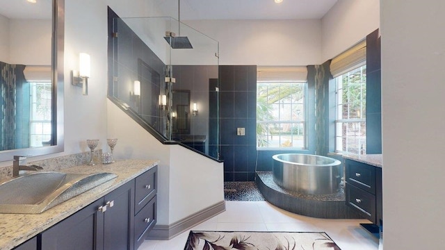 bathroom with vanity, tile patterned floors, and separate shower and tub