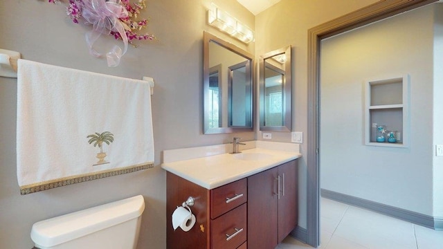 bathroom with vanity, tile patterned flooring, and toilet