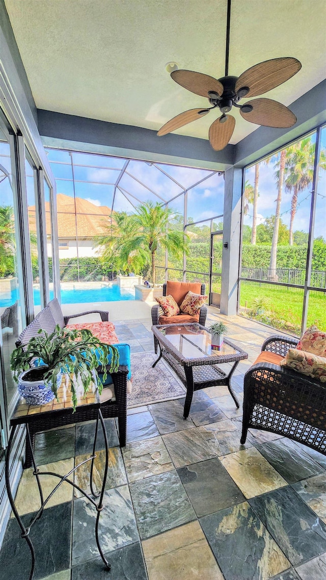 sunroom / solarium with a mountain view and ceiling fan