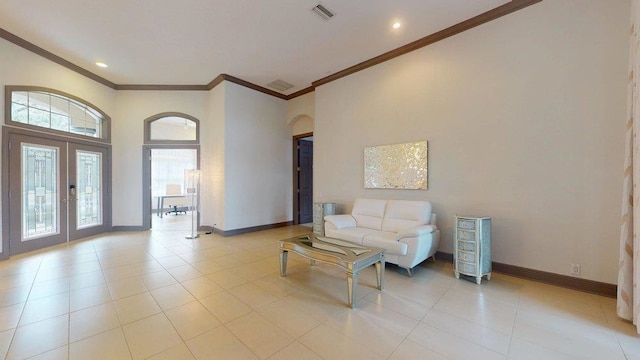 tiled living room with french doors and crown molding