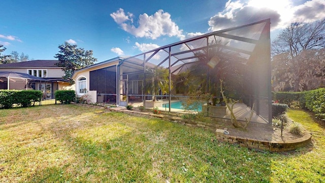 exterior space with a lanai and a lawn