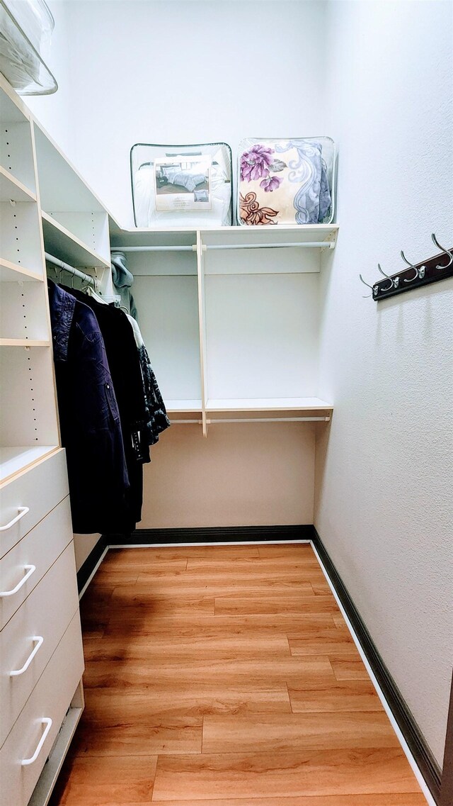 spacious closet featuring hardwood / wood-style flooring