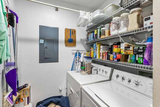 laundry room featuring electric panel and separate washer and dryer