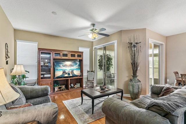 living room with hardwood / wood-style flooring and ceiling fan