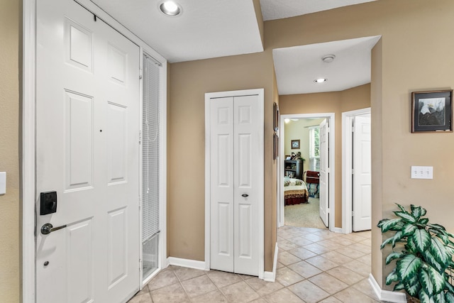 foyer entrance with light tile patterned flooring