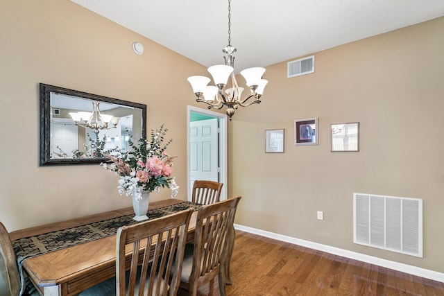 dining space featuring an inviting chandelier and hardwood / wood-style flooring