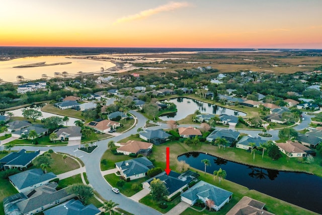 aerial view at dusk with a water view