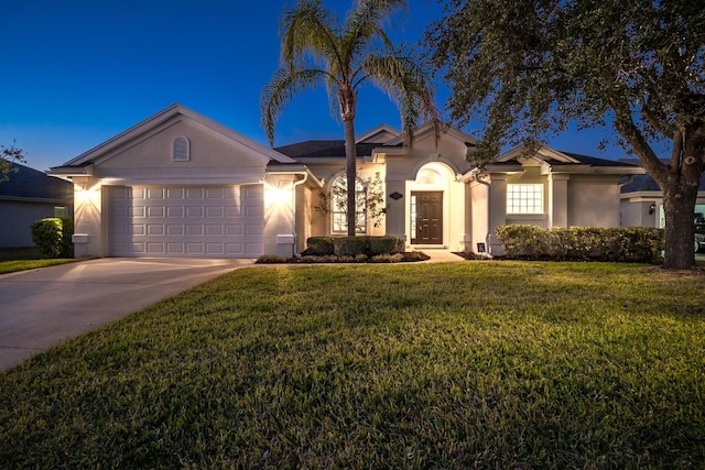 single story home featuring a garage and a front lawn