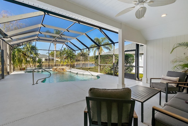 view of swimming pool with ceiling fan and a water view