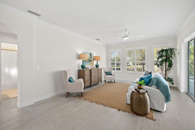 living area featuring light hardwood / wood-style flooring, ceiling fan, and ornamental molding