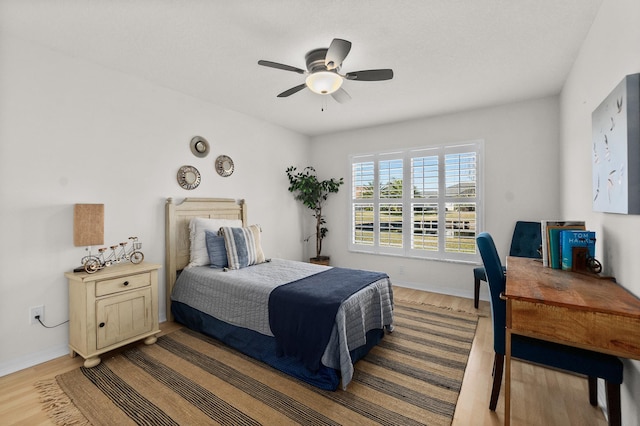 bedroom featuring light wood-type flooring and ceiling fan