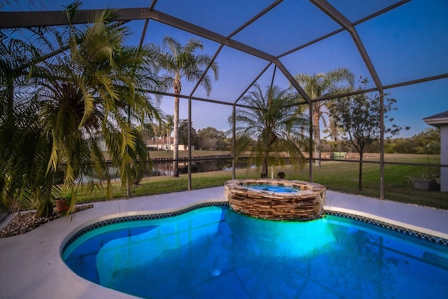 pool at dusk featuring an in ground hot tub, a water view, and a lanai