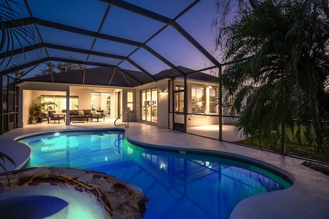 pool at dusk featuring a lanai, a patio, an outdoor hangout area, and ceiling fan