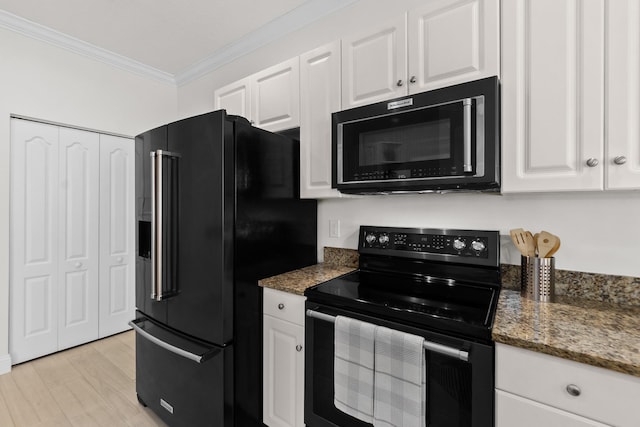 kitchen with black appliances, dark stone countertops, white cabinets, and ornamental molding