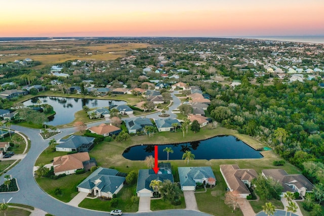 aerial view at dusk with a water view