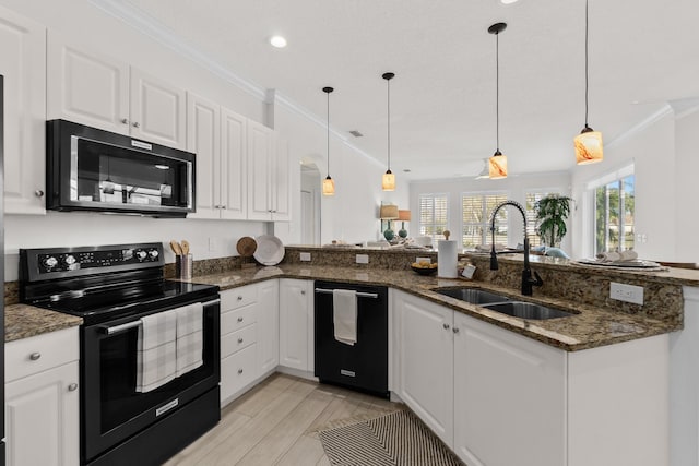 kitchen featuring white cabinets, black appliances, dark stone countertops, sink, and hanging light fixtures