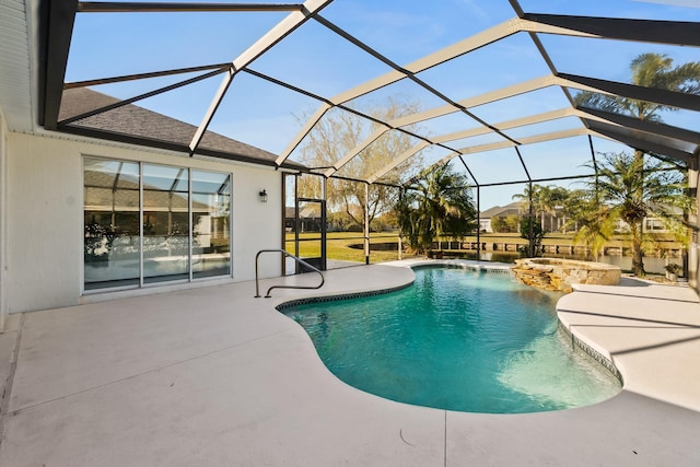 view of pool with glass enclosure, an in ground hot tub, and a patio