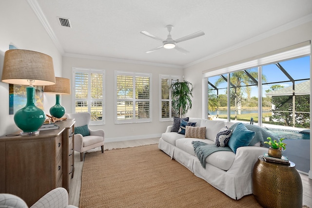 sunroom / solarium featuring ceiling fan and a water view