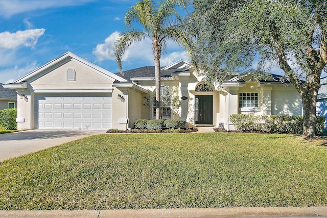 ranch-style home featuring a garage and a front yard