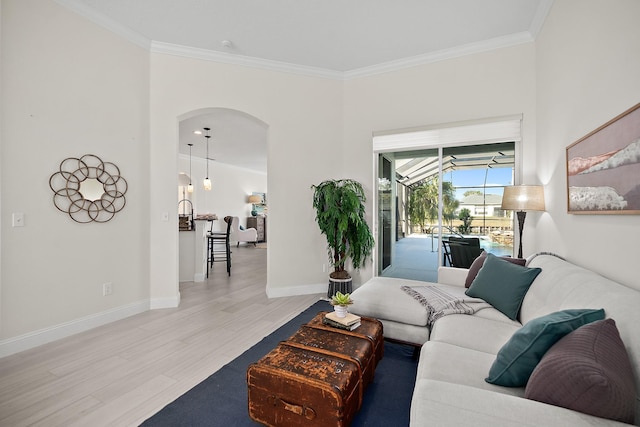 living room with crown molding and light hardwood / wood-style floors