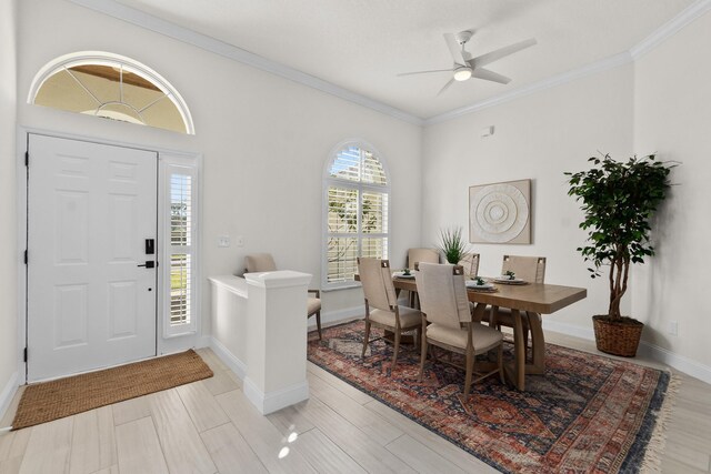 entrance foyer featuring ceiling fan and ornamental molding