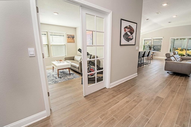 hallway featuring vaulted ceiling