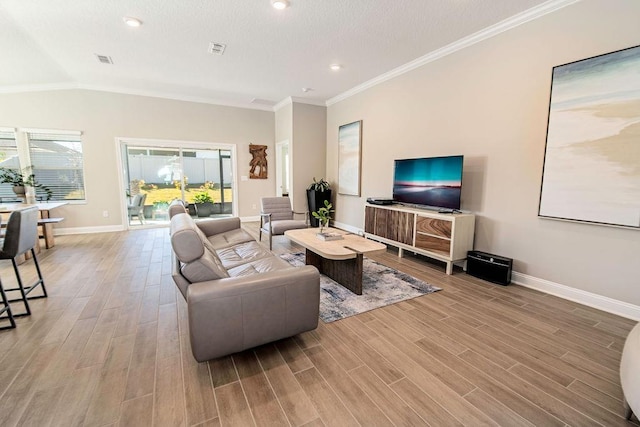 living room with light hardwood / wood-style flooring, vaulted ceiling, and crown molding