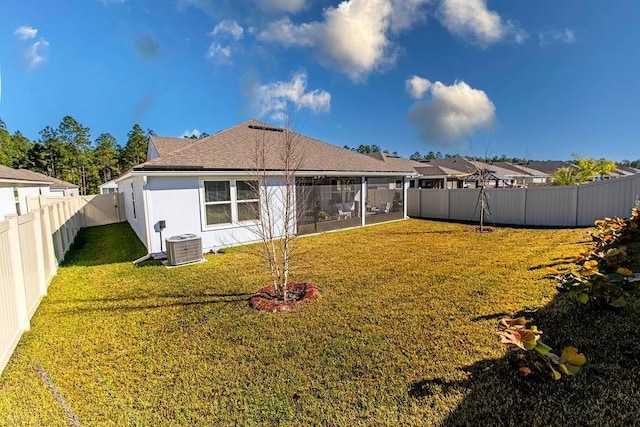 back of property with a yard and central AC unit