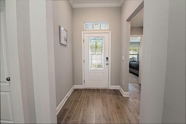 doorway to outside featuring ornamental molding